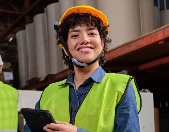 Woman in high-visibility vest representing industrial and warehouse recruitment