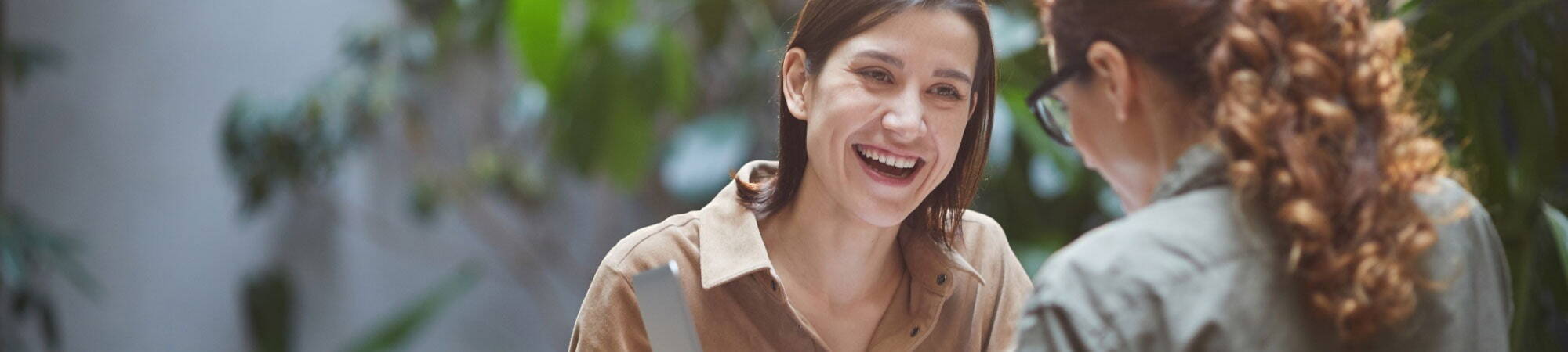 Two recruiters smiling at eachother 