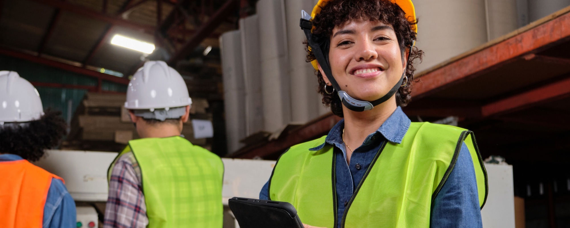 Woman in high-visibility vest representing industrial and warehouse recruitment