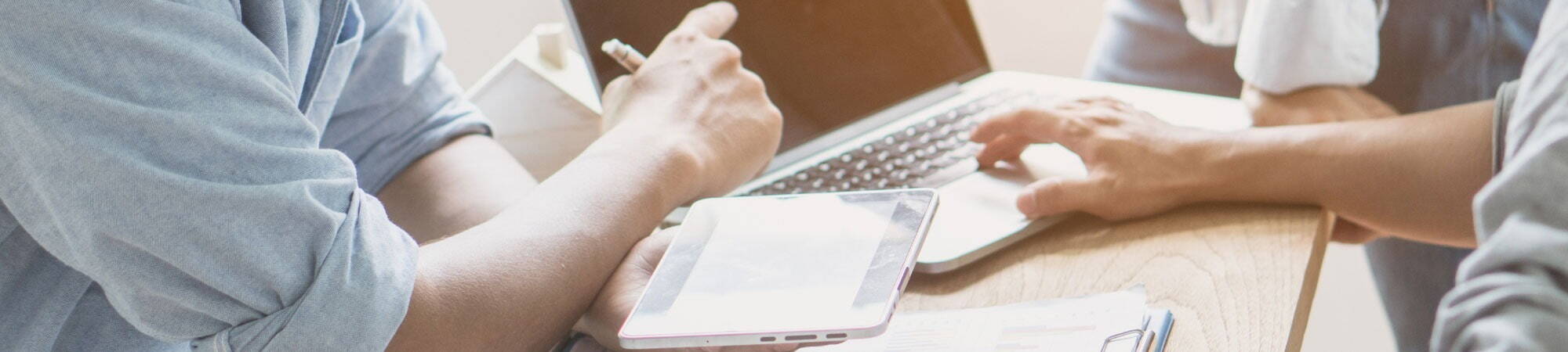 Two recruiters using an ipad and laptop